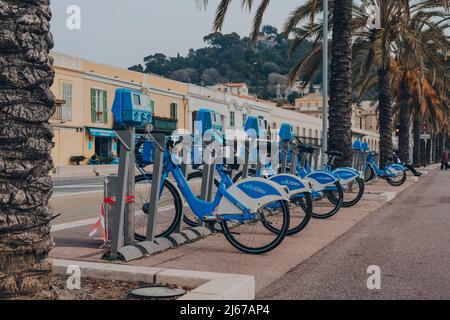 Nice, France - March 11, 2022: Row of rental Velobleu bikes parked on The Promenade des Anglais in Nice, a famous tourist destination on the French Ri Stock Photo