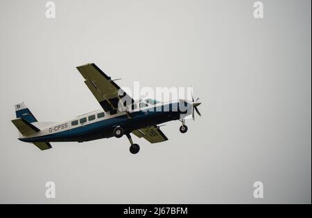 Cessna 208b Grand Caravan G-CPSS light aircraft ascends after take-off Stock Photo