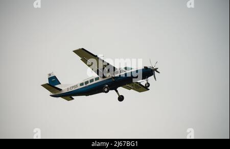 Cessna 208b Grand Caravan G-CPSS light aircraft ascends after take-off Stock Photo
