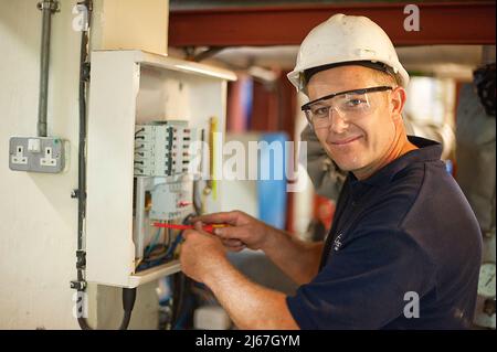Maintenance engineer working and looking ta the camera Stock Photo
