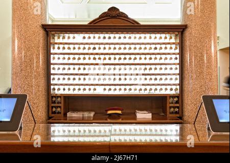 Hotel front desk with room keys Stock Photo