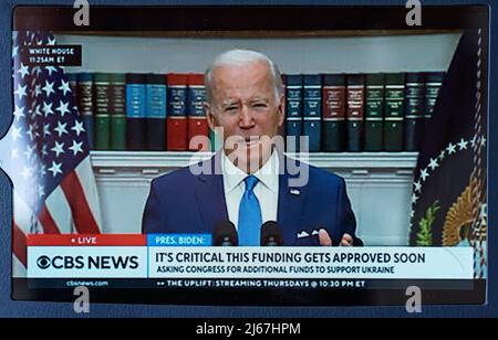 In this photo illustration, an iPad screen showing US President Joe Biden speaking at the White House with a statement on assistance to Ukraine. Stock Photo