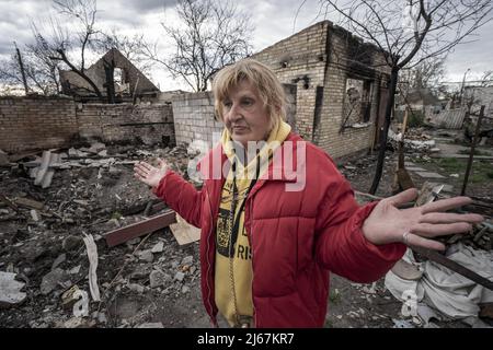 Irpin, Ukraine. 28th Apr, 2022. Natalia Tsyukalo, 62, demonstrates how she hid in her cellar from the Russian shelling that hit the apartments across the street from her home in Irpin, Ukraine April 27, 2022. The United States has credible evidence of Russian troops executing surrendering Ukrainians in Donetsk region, a U.S. official told U.N. member states seeking to hold those responsible for war crimes committed by Russia to account. Credit: UPI/Alamy Live News Stock Photo