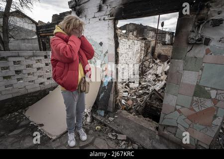 Irpin, Ukraine. 28th Apr, 2022. Natalia Tsyukalo, 62, demonstrates how she hid in her cellar from the Russian shelling that hit the apartments across the street from her home in Irpin, Ukraine April 27, 2022. The United States has credible evidence of Russian troops executing surrendering Ukrainians in Donetsk region, a U.S. official told U.N. member states seeking to hold those responsible for war crimes committed by Russia to account. Credit: UPI/Alamy Live News Stock Photo