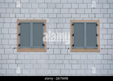 Gray plastic window sashes on brick wall Stock Photo