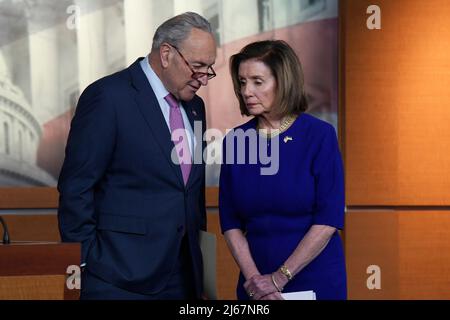 Washington DC, USA. 28th Apr, 2022. House Speaker Nancy Pelosi (D-CA) and Senate Majority Leader Chuck Schumer (D-NY) talk to each other during a press conference at HVC/Capitol Hill in Washington. Credit: SOPA Images Limited/Alamy Live News Stock Photo