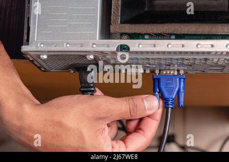top view brunette male hand installing vga cable in computer, technology and technical service concept, closeup with copy space. Stock Photo