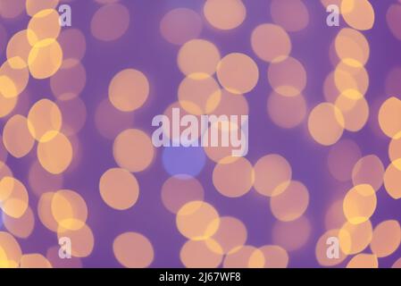 Blurred abstract: blurry orange light circles in the purple background. Bokeh effect Stock Photo