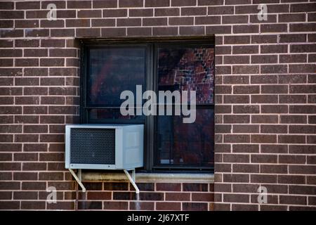 Window and AC in the brick building Stock Photo