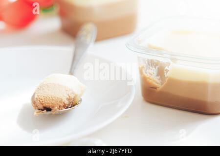 On white plate lies spoon with three types of chocolate Stock Photo