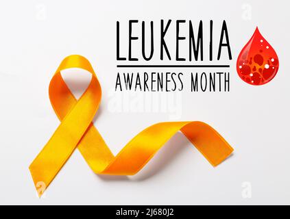 Top view of orange ribbon on dark wood background. Leukemia