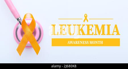 Orange ribbon, stethoscope and text LEUKEMIA AWARENESS MONTH on light background Stock Photo