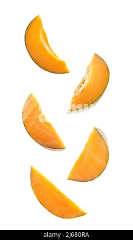 Flying slices of ripe melon isolated on white Stock Photo