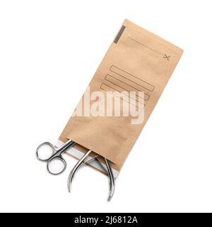 Paper bag with clean manicure tools on white background Stock Photo