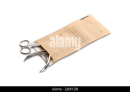 Paper bag with clean manicure tools isolated on white background Stock Photo