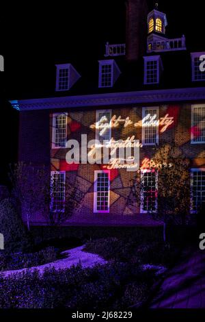 Light and Liberty go Together. Thomas Jeffeston quote written in light at garden entrance, Colonial Williamsburg Palace. CW Light Show 2022. Vertical. Stock Photo