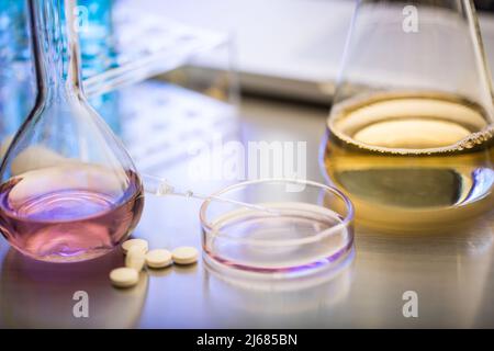 Group of object, pills, dropper, conical flask, funnel, Petri dish, test tube, laptop - stock photo Stock Photo