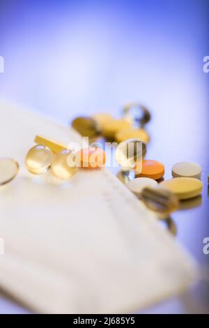 Different kinds of pills and softgels on N95 masks - stock photo Stock Photo