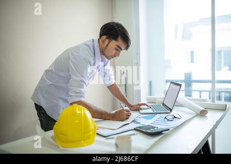 Business man working with laptop and documents on his desk.analyzing data in office Stock Photo