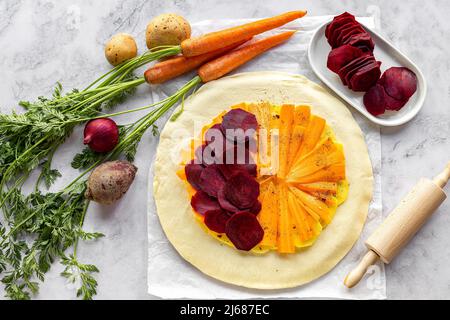 Step by step recipe of savory root vegetable galette. Step 3.  Stock Photo