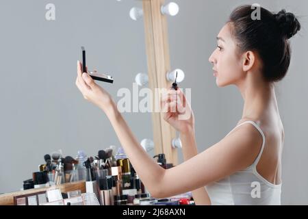 The young woman makeup in the dressing room Stock Photo
