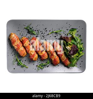 Isolated portion of bacon rolls appetizer on white Stock Photo