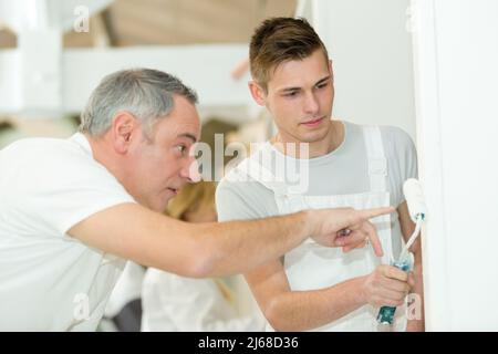 young house painter and decorator apprentice trainee Stock Photo