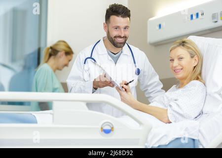 doctor explaining consent form to senior patient Stock Photo