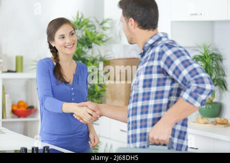 woman with contractor at kitchen discussing repair Stock Photo