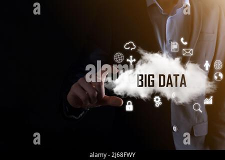 Businessman holds the inscription word BIG DATA. Padlock , brain ,man, planet,graph, magnifier, gears, cloud, grid, document, letter, phone icon Stock Photo