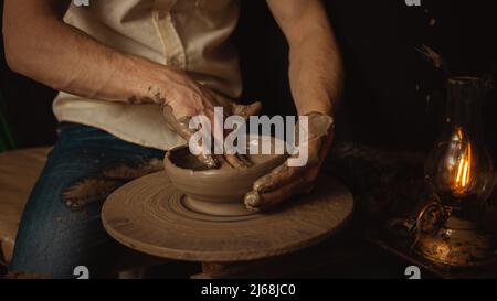 man makes Plate in pottery workshop, clay product, authentic atmosphere, background. Lifestyle, indoor. closeup hands banner Stock Photo