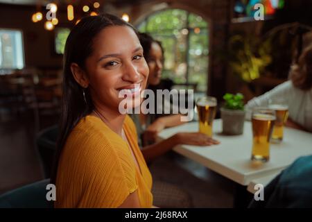 african american female smiling while enjoying evening with friends Stock Photo
