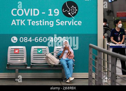 Bangkok, Thailand. 29th Apr, 2022. A woman wearing a face mask as a preventive measure against the spread of coronavirus sits in front of a COVID-19 ATK Testing Service room at Suvarnabhumi international airport. On Nov 1, 2022, the first day of the country's reopening campaign to jump-start the pandemic-hit tourism sector. The government has said it has not cancelled the Thailand Pass registration requirement for foreign travelers yet but it will be made more convenient and quicker to obtain. However, from May 1 the Test & Go entry scheme will be cancelled, without any need for bookings for a Stock Photo