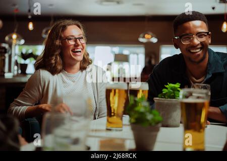 diverse friends out for dinner drinking beers  Stock Photo