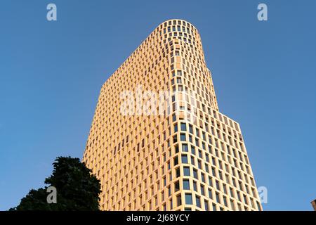 Upper West high rise building in the city of Berlin. Also known as Atlas Tower in Charlottenburg in front of a blue sky while the sun is going down. Stock Photo