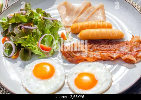 American breakfast with two sunny eggs at outdoor restaurant in hotel Stock Photo