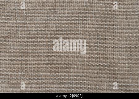 Rough fabric texture of a seating furniture. Beige brown textile material pattern. Structure of a chair. Stock Photo