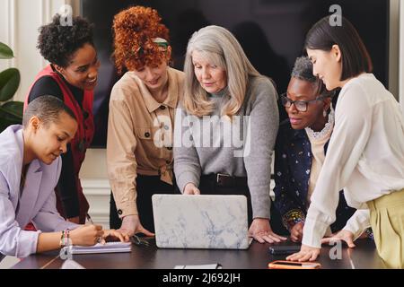 Multi ethnic mixed age range women in creative business meeting Stock Photo