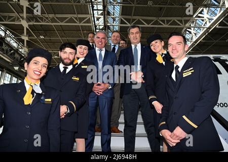Munich, Germany. 29th Apr, 2022. 29 April 2022, Bavaria, Munich: Carsten Spohr, Chairman of the Executive Board and CEO of Deutsche Lufthansa (5th from left) and Minister President Markus Söder (CSU) (8th from left) stand on the aircraft's gangway with the crew in a maintenance hangar at the airport during the christening of a Lufthansa Airbus A350 with the name 'Munich'. Photo: Felix Hörhager/dpa Credit: dpa picture alliance/Alamy Live News Stock Photo