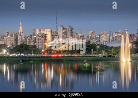 The downtown urban skyline reflected in Lago das Garcas lake at twilight, Ibirapuera Park, Sao Paulo, Brazil Stock Photo