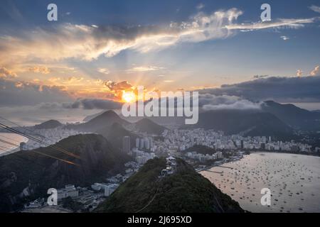 Sunset over the city skyline and Rio's mountains and beaches from the summit of Sugar Loaf mountain, Rio de Janeiro, Brazil Stock Photo