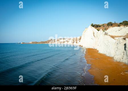 Sunrise over the gold sand of Xi beach surrounded by majestic limestone cliffs, Kefalonia, Ionian Islands, Greek Islands, Greece, Europe Stock Photo