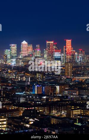 Aerial view of the illuminated Canary Wharf skyline at night with ...