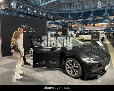 Stockholm, Sweden. 29th Apr, 2022. (220429) -- STOCKHOLM, April 29, 2022 (Xinhua) -- People look at a Jaguar electric vehicle during the Swedish eCarExpo 2022 in Stockholm, Sweden, April 29, 2022.  Swedish eCarExpo 2022 kicked off here Friday. More than 100 exhibitors showcase their latest products during the 3-day event. (Xinhua/Fu Yiming) Credit: Xinhua/Alamy Live News Stock Photo