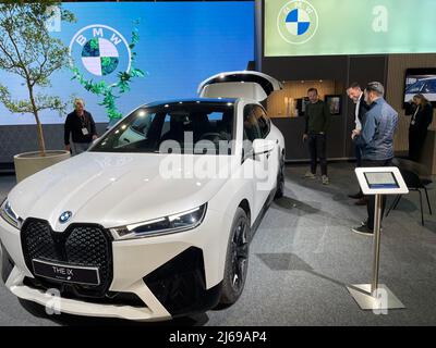 Stockholm, Sweden. 29th Apr, 2022. (220429) -- STOCKHOLM, April 29, 2022 (Xinhua) -- People look at a BMW electric vehicle during the Swedish eCarExpo 2022 in Stockholm, Sweden, April 29, 2022.  Swedish eCarExpo 2022 kicked off here Friday. More than 100 exhibitors showcase their latest products during the 3-day event. (Xinhua/Fu Yiming) Credit: Xinhua/Alamy Live News Stock Photo