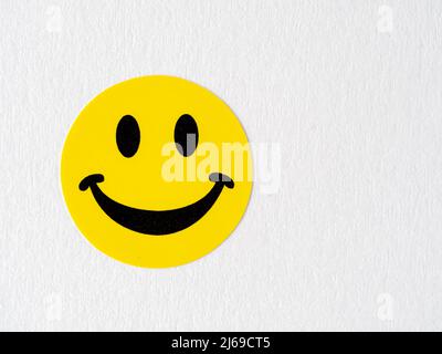 yellow arts and craft smilling happy face sticker on a white background Stock Photo