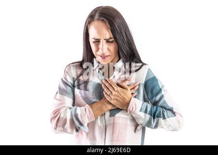 Young woman with hands on chest with heart arrhythmia. Isolated on white. Stock Photo