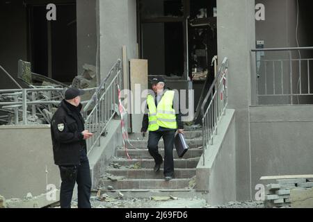 KYIV, UKRAINE - APRIL 29, 2022 - Investigators collect evidence of the destruction caused by a Russian missile that hit a residential building in the Stock Photo