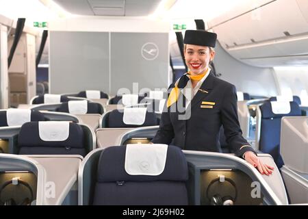 Munich, Germany. 29th Apr, 2022. Flight attendant, stewardess, steward, cabin crew in empty business class. Lufthansa aircraft christening Airbus A350 MUENCHEN on April 29th, 2022 in the aircraft hangar Flight Operation Center at Franz Josef Strauss Airport in Munich. Credit: dpa picture alliance/Alamy Live News Stock Photo