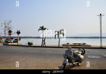 Thai people foreign travelers riding retro vintage classic motorcycle scooter stop travel visit relax at Kwan Phayao lake and large swamp freshwater p Stock Photo